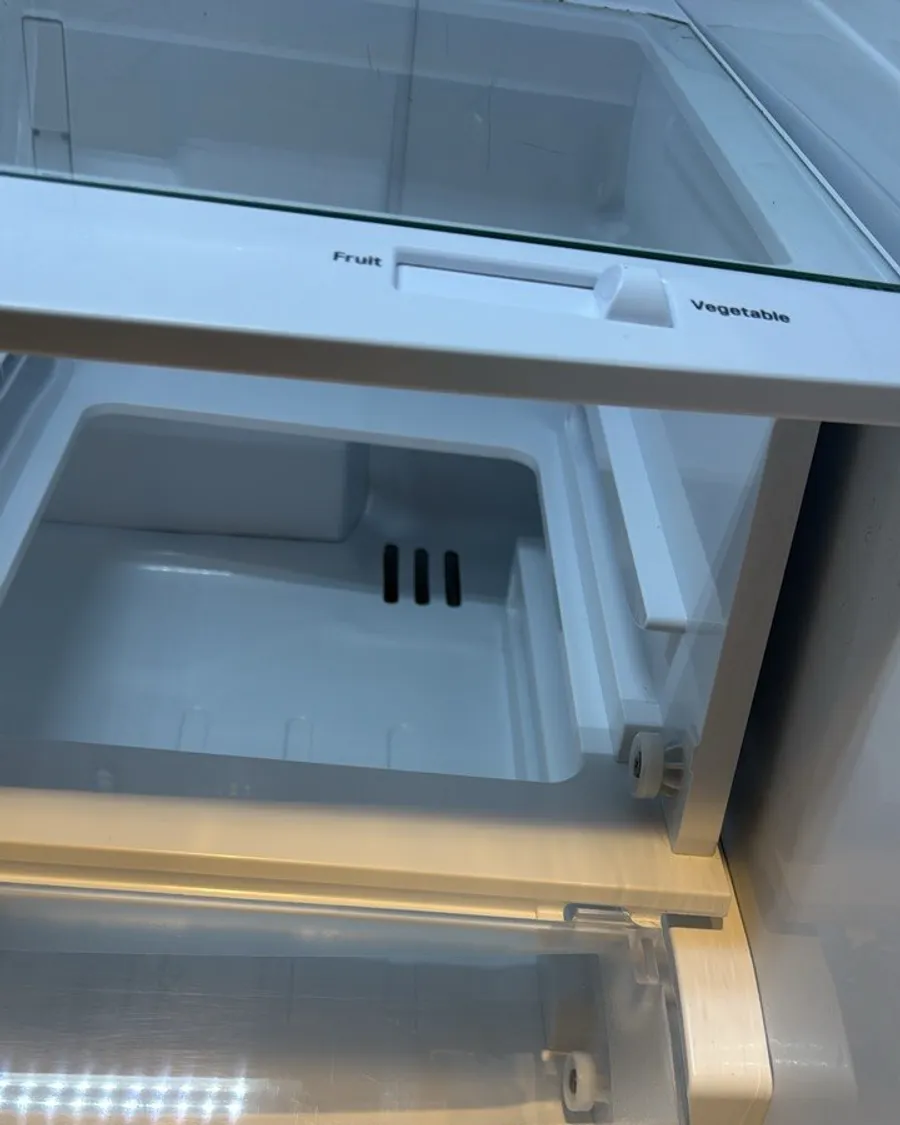 The same fridge shelf and the drawer under it, clean