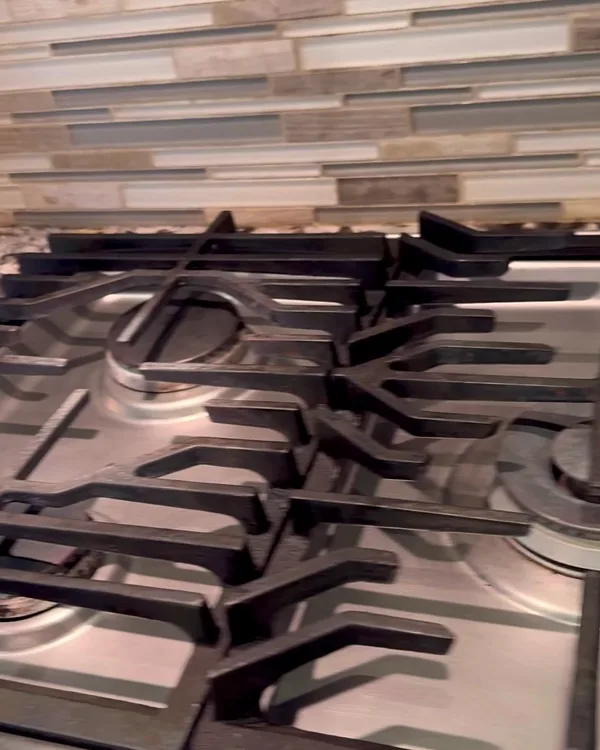 The same stovetop with clean grates and steel