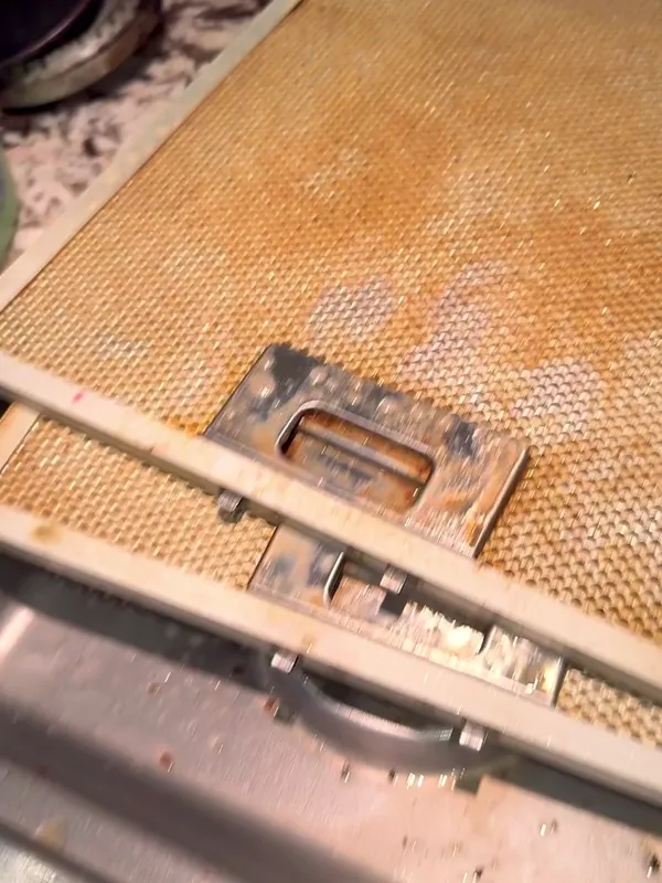 Range hood filter covered in brown grease