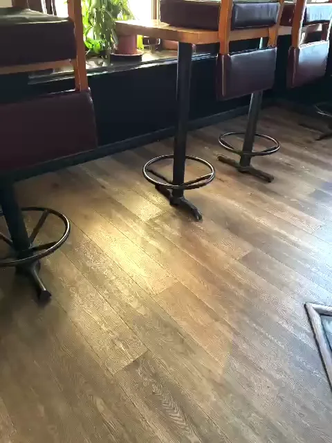 Clean floor under tables with chairs lifted on top