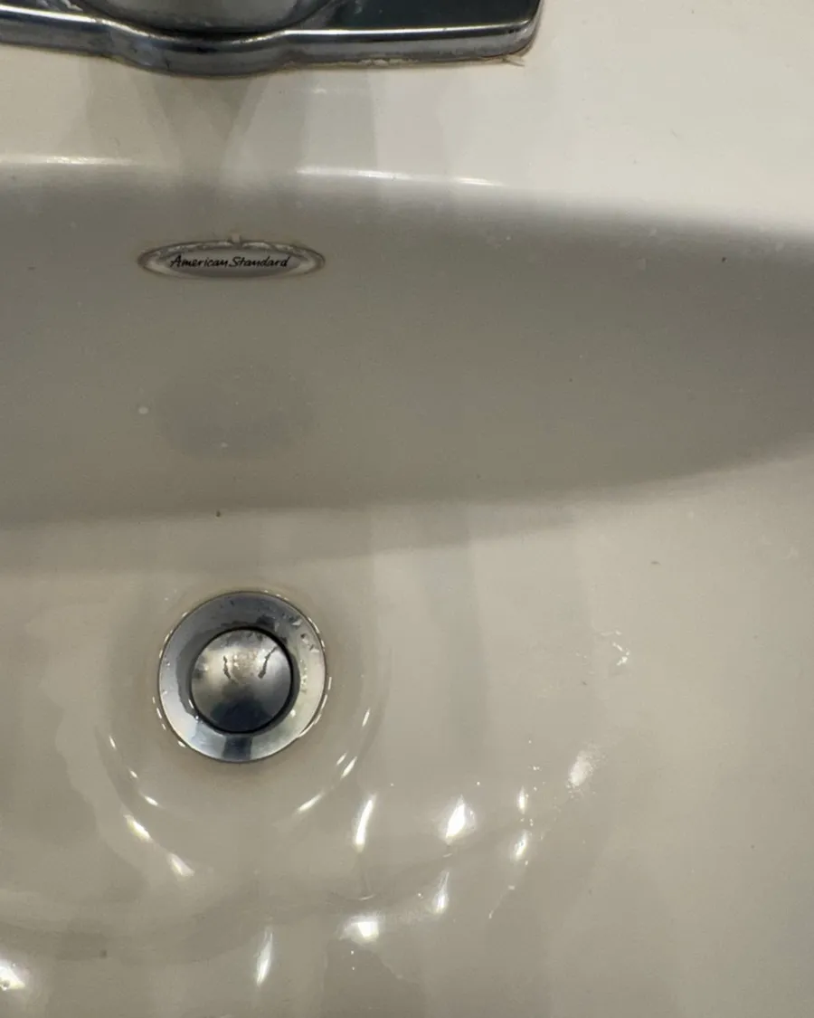 Close view of a sink drain and the bowl around it