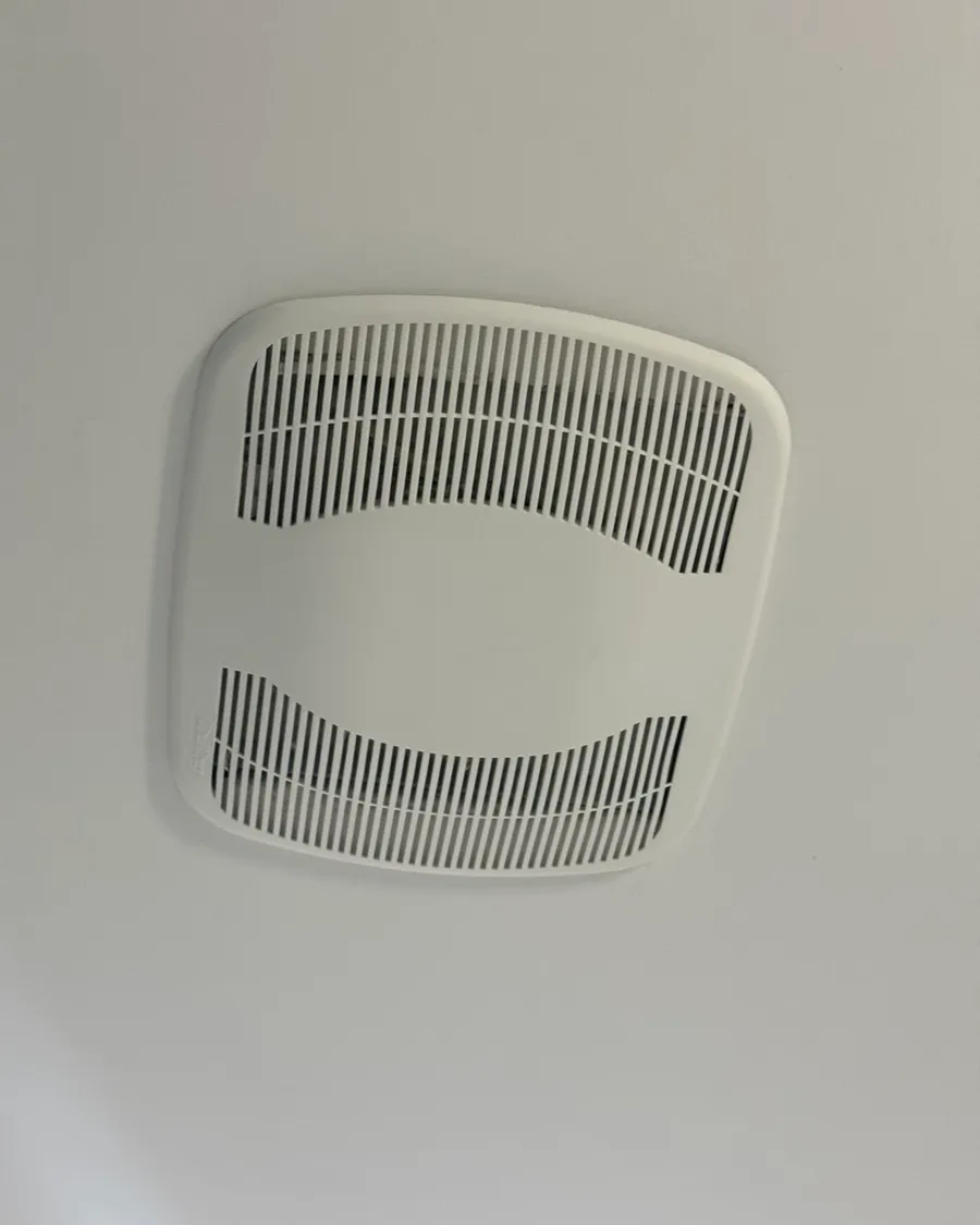 White cover of a bathroom ceiling fan