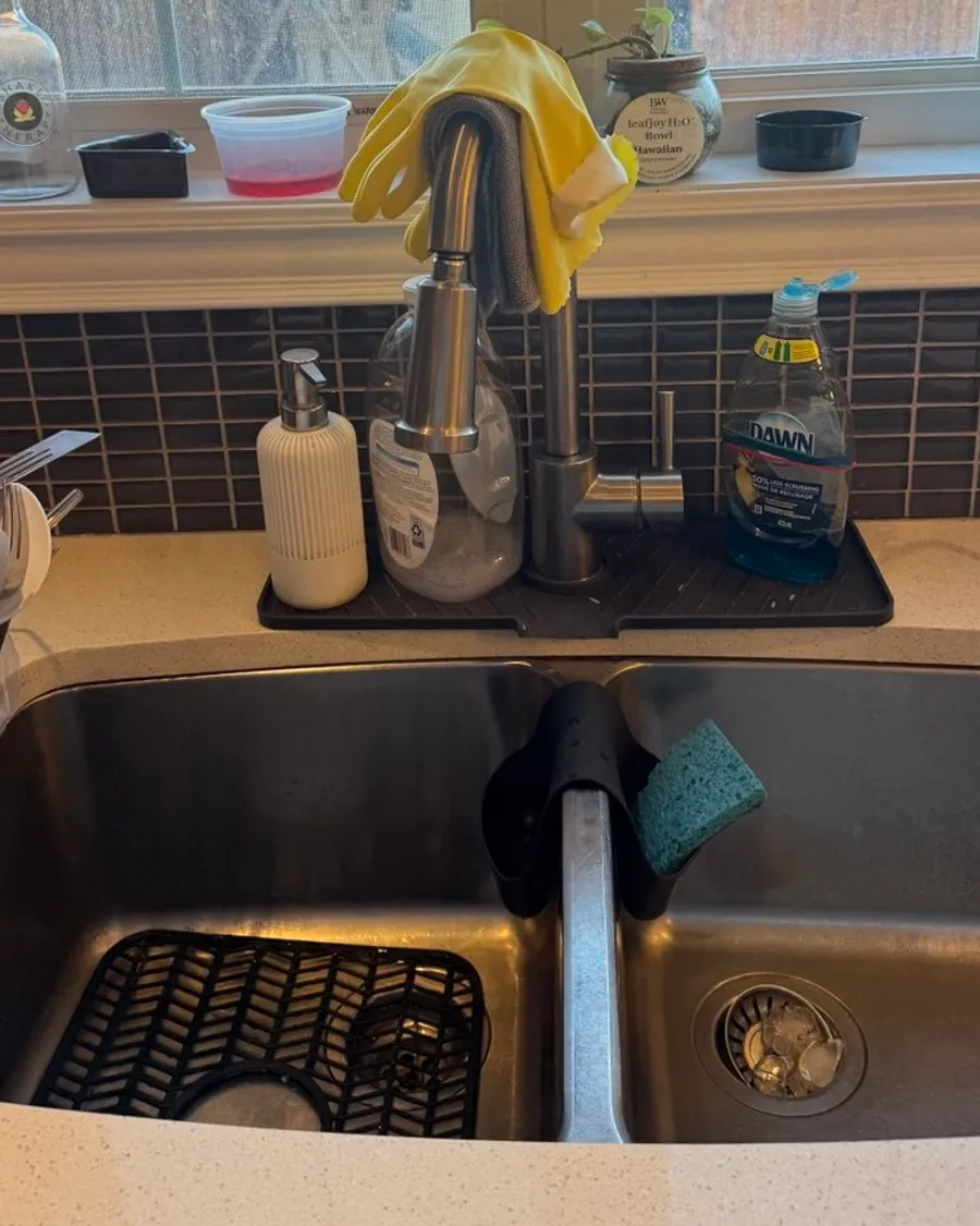 Stainless steel double sink with a pull-down faucet and a soap tray