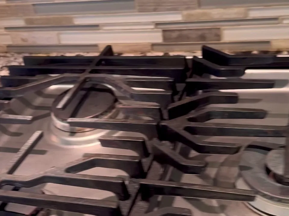 Gas stovetop with clean steel surface and grates after a deep clean